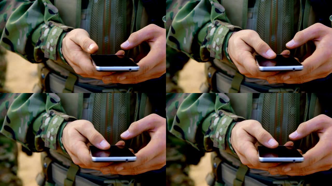 军事训练中使用手机的高加索军事士兵的中段4k