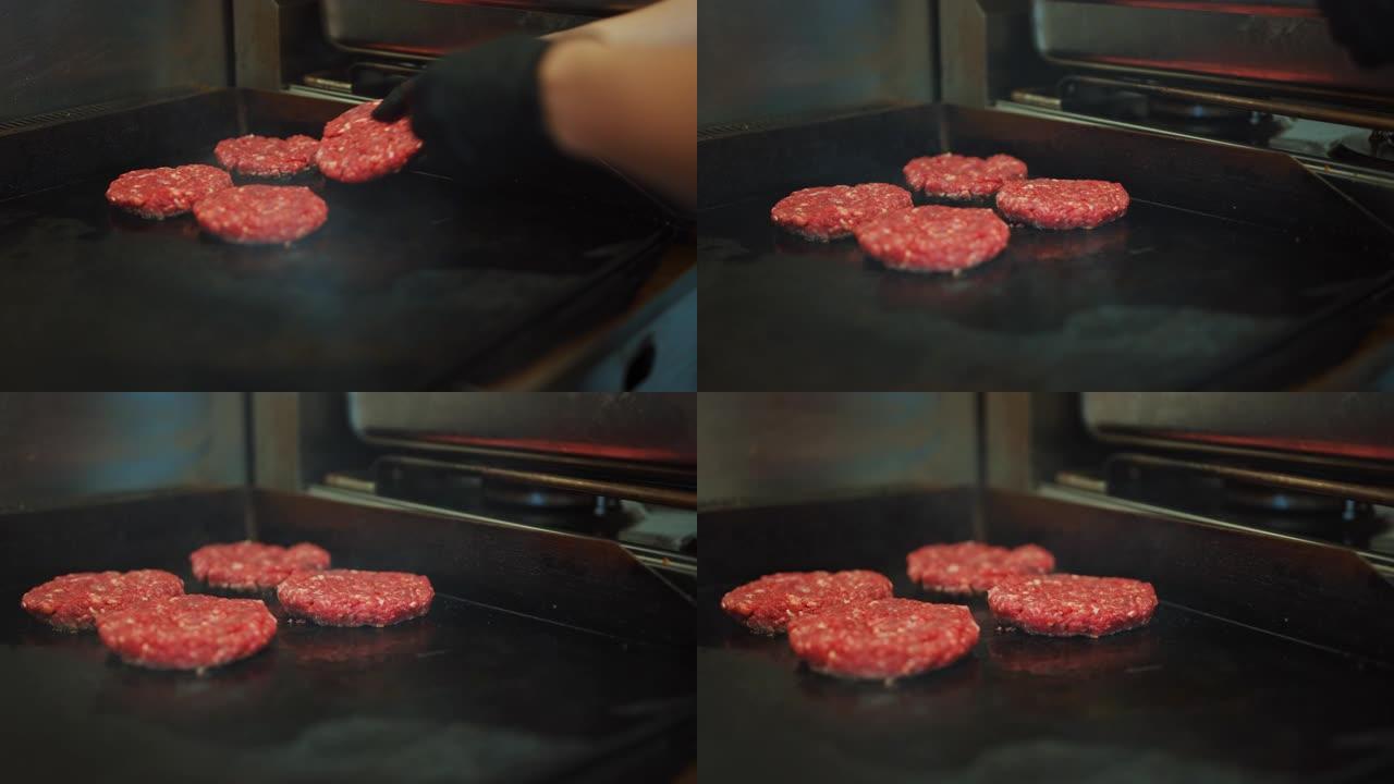 在烤架上准备肉饼的美味特写镜头。新鲜的碎牛肉被放在热气或电烤架上。用新鲜碎肉制作美味汉堡的过程。