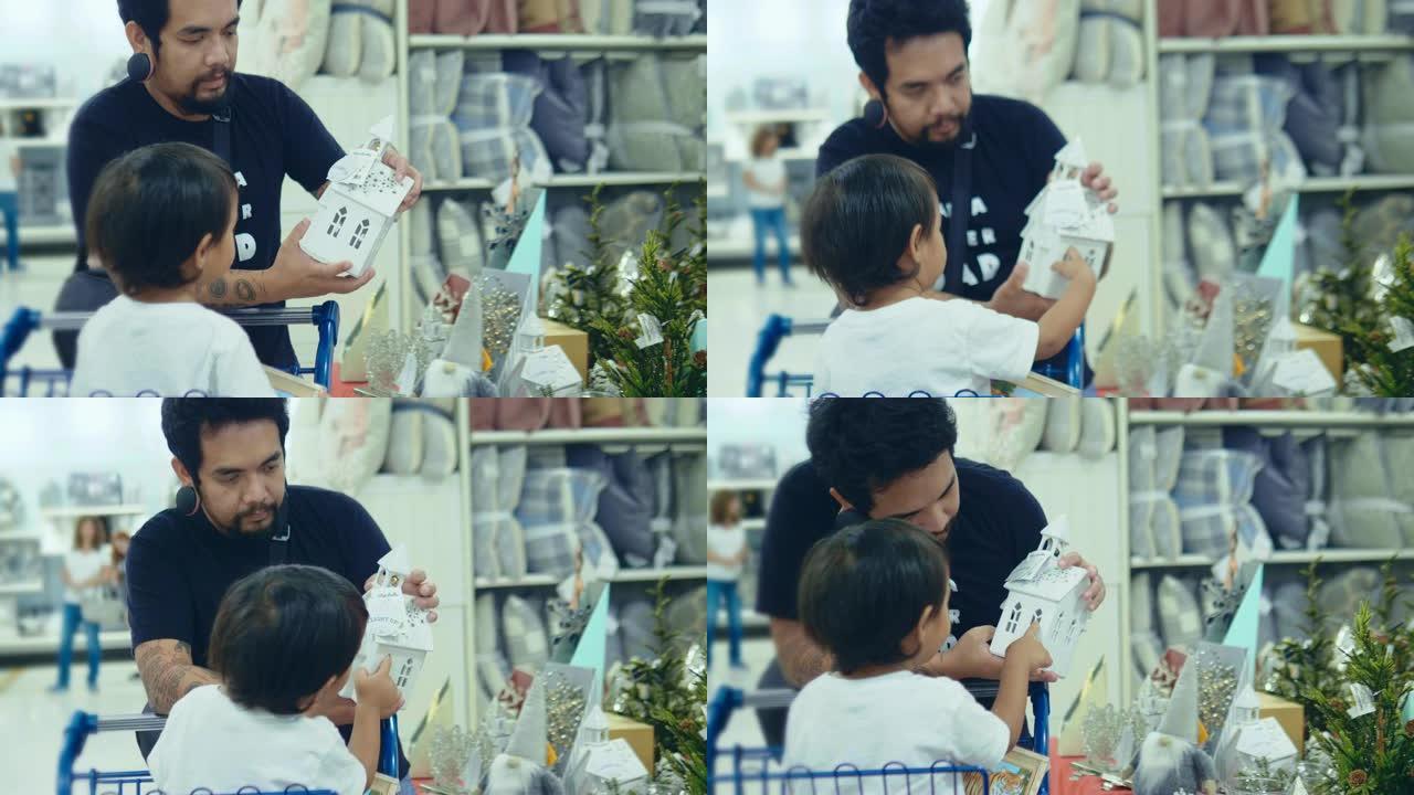 亚洲父亲正在超市和儿子一起购物过圣诞节。