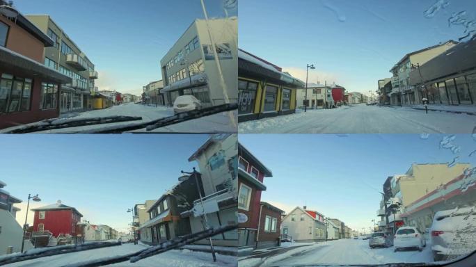 MS Car的观点在冰岛冰雪覆盖的城镇大街上行驶