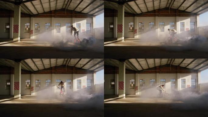 在空仓库中使用烟雾弹的BMX骑手