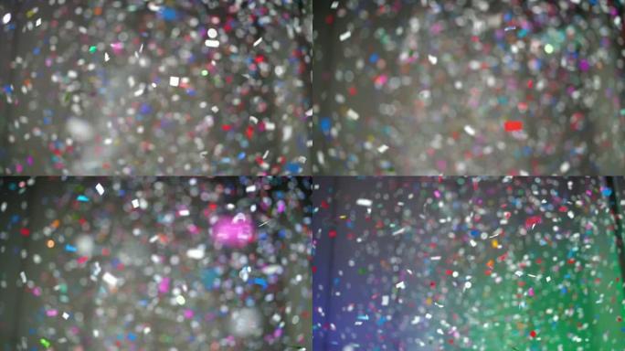 4k慢动作镜头，彩色五彩纸屑从房间上方掉落，以新年快乐和派对概念庆祝