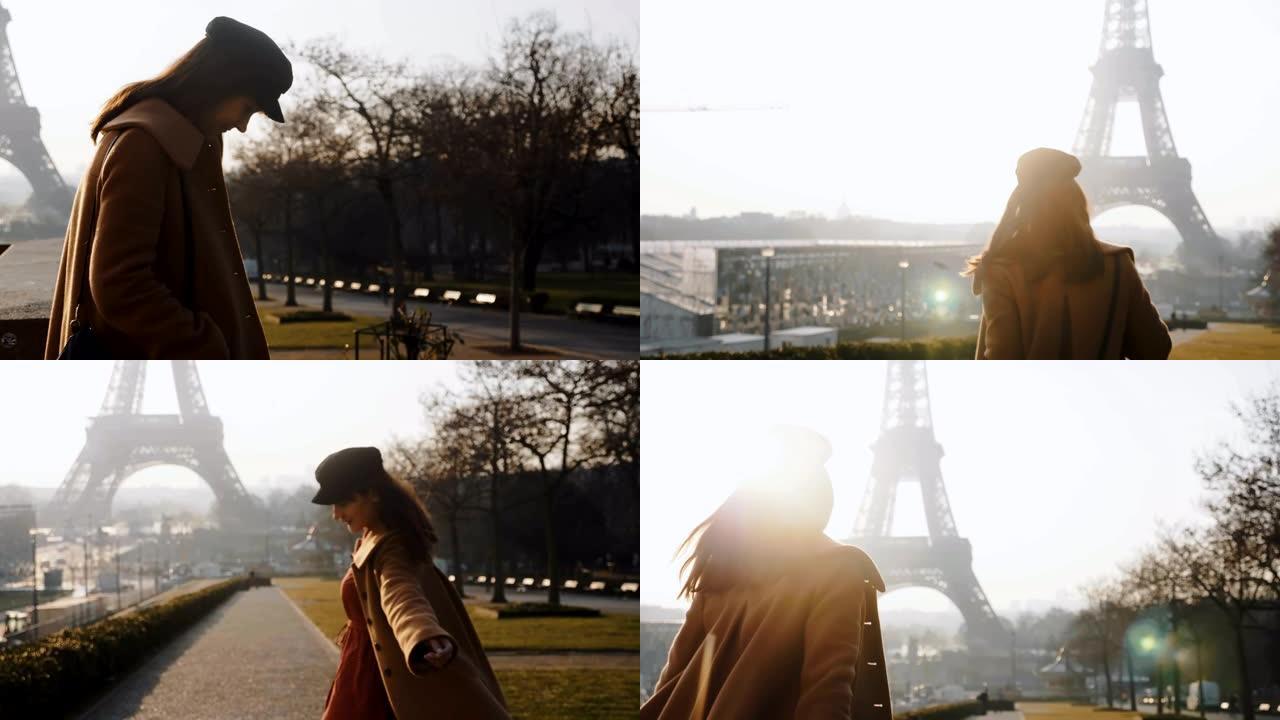 相机跟随快乐的当地博主女人散步，在雄伟的巴黎埃菲尔铁塔附近摆姿势，对着相机慢动作微笑。