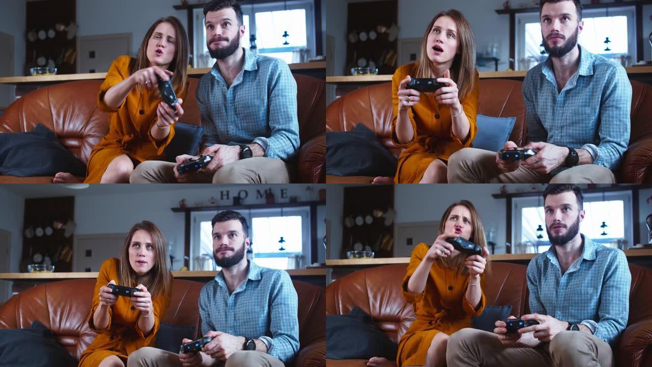 年轻快乐的高加索已婚夫妇用操纵杆玩游戏机，在家一起玩慢动作。