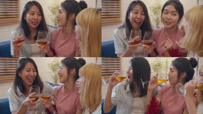 一群亚洲女性在家聚会，女性晚上在客厅的沙发上喝鸡尾酒聊天。青少年年轻朋友玩游戏，庆祝节日概念。慢动作
