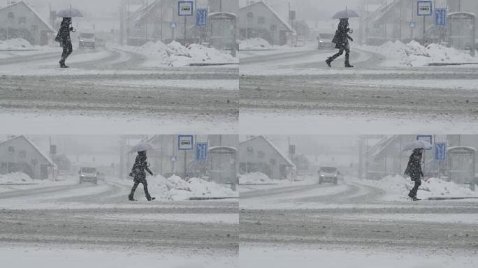 慢动作: 在暴风雪中，无法识别的女人穿过白雪皑皑的街道。