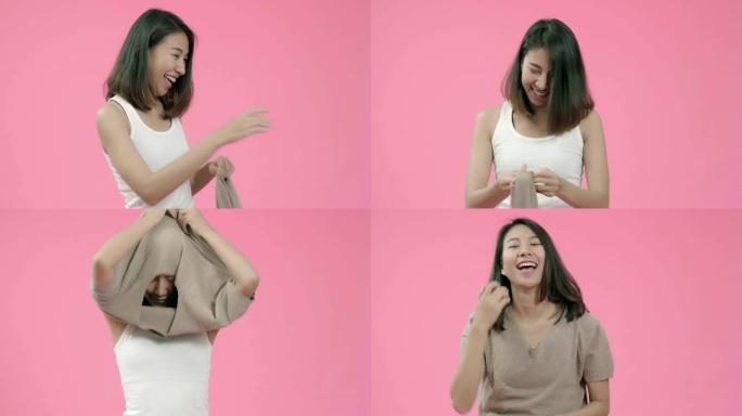 年轻漂亮时尚的亚洲女性穿着粉色背景的休闲服工作室拍摄。快乐微笑可爱的快乐女人快乐成功。