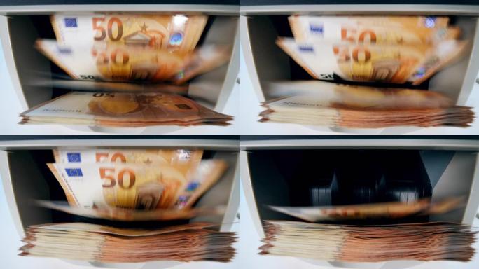 在银行的自动机器中计入橙色欧元。