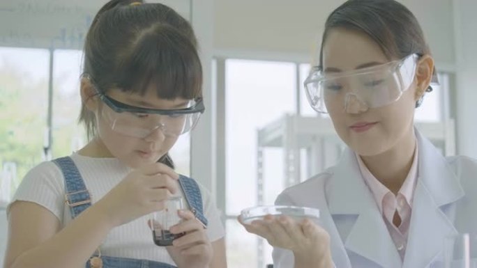 小亚洲学生女孩在科学实验实验班学习。科学与教育。