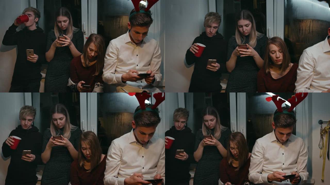 青少年朋友在聚会中使用智能手机