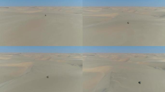 4k空中飞越纳米比亚纳米布沙漠骨架海岸沙丘上行驶的4x4车辆