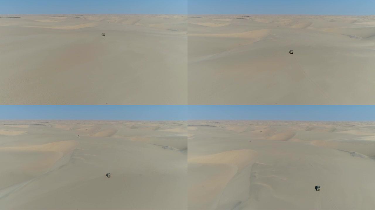 4k空中飞越纳米比亚纳米布沙漠骨架海岸沙丘上行驶的4x4车辆