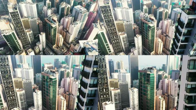 香港中部飞行无人机的鸟瞰图。大城市的现代摩天大楼和高楼大厦，城市交通系统。相机从上到下移动。