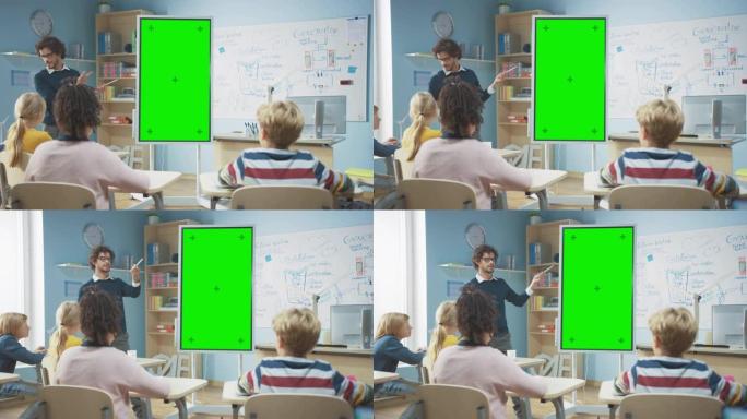 在小学教室里: 老师使用垂直绿色模拟屏幕交互式数字白板向不同的学童群体解释课程。多民族儿童学习科学