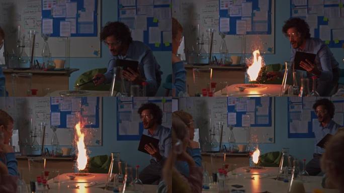 学校化学教室: 全神贯注的孩子们观看热情的老师如何通过点燃火粉来展示科学实验，创造美丽的烟花。孩子们