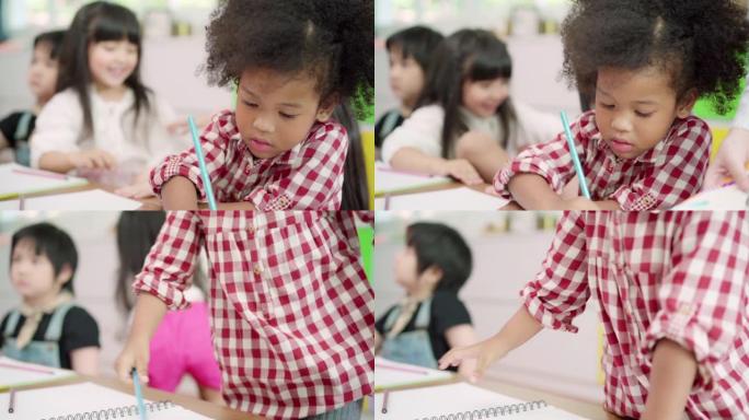 慢动作-一群孩子在教室里画画，多民族的年轻男孩和女孩在小学快乐有趣的学习和在纸上画画。孩子们在学校画