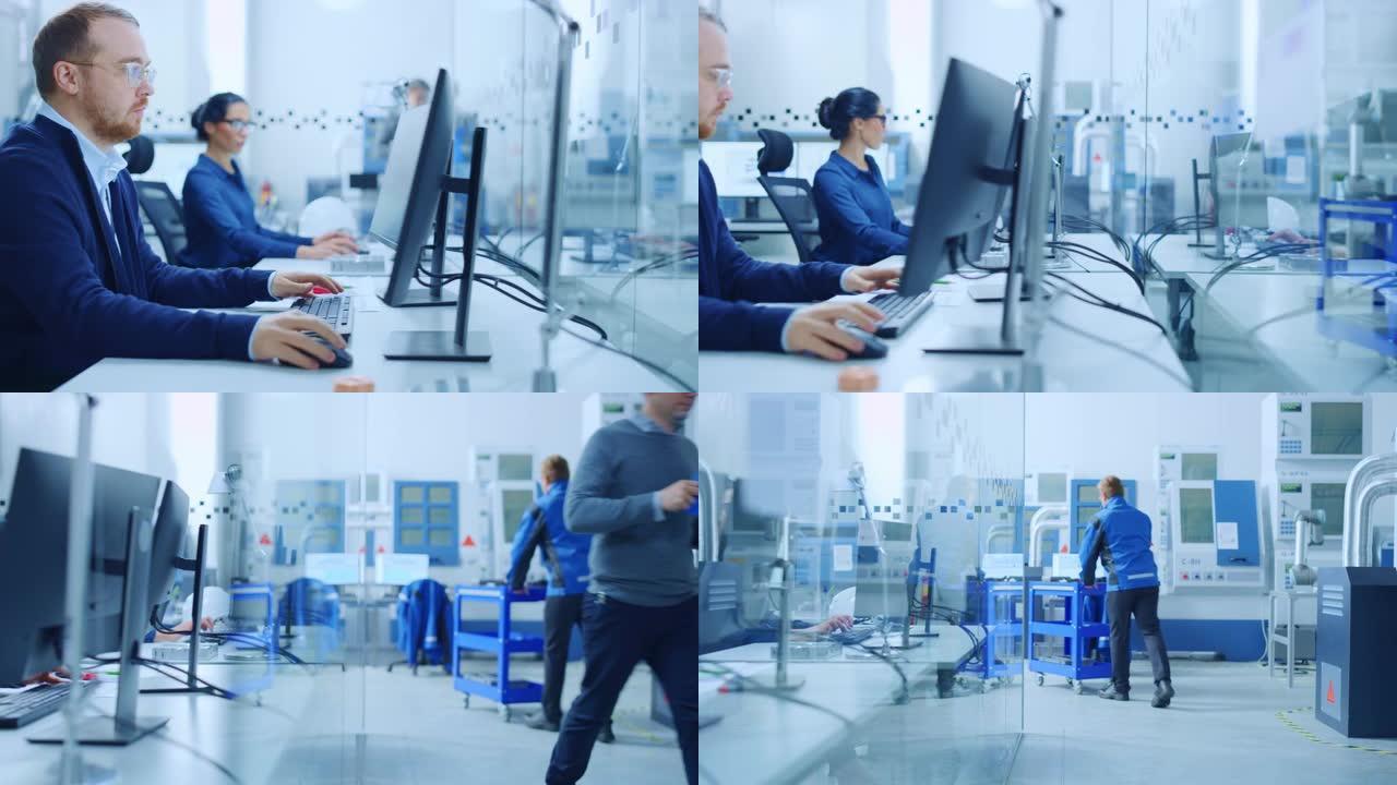 工厂内部玻璃办公团队的工业工程师在PC上工作，在现代设施车间的外部隔间中使用高科技工业数控机械，机械