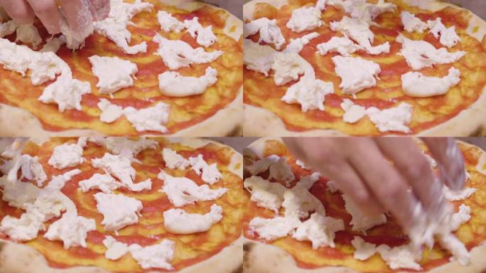 靠近披萨厨师的手，用高品质的意大利美食配料填充披萨。