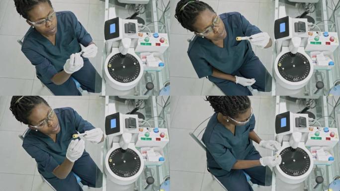 年轻的非洲女性病理技术员在实验室工作的高角度视频