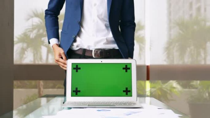 绿屏笔记本电脑上的商人演示，显示电脑显示器色键