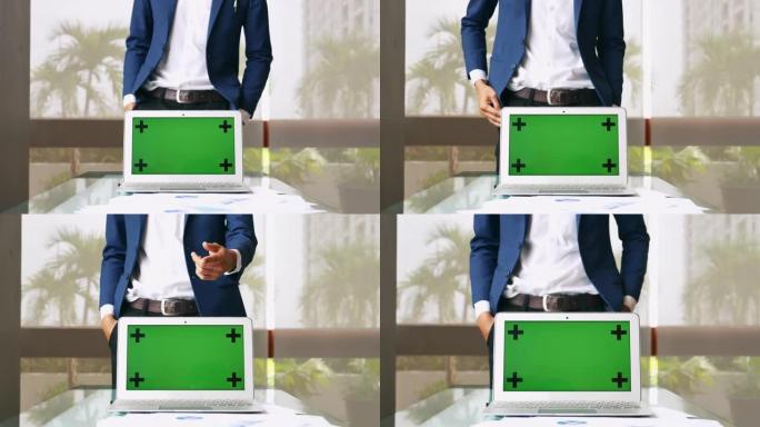 绿屏笔记本电脑上的商人演示，显示电脑显示器色键