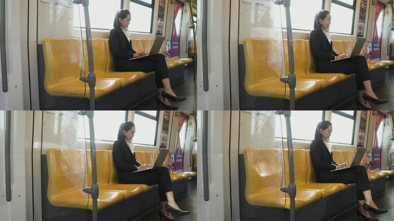 女商人在火车上使用笔记本电脑工作。