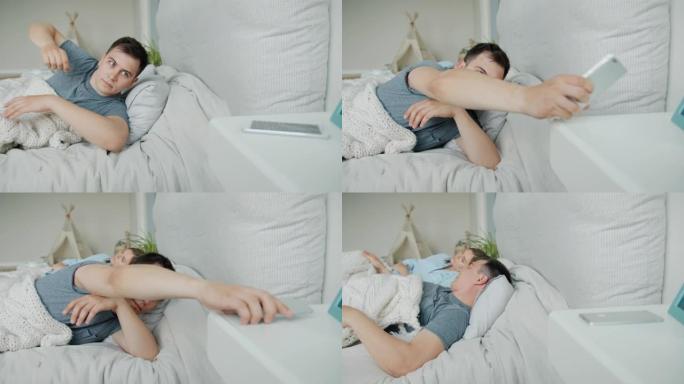 男人和妻子睡在床上，然后用智能手机放松入睡