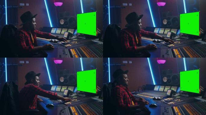在音乐录音室工作的时尚音频制作人，使用绿屏PC，混音器板均衡器和控制台来创建新的热门曲目和歌曲。富有