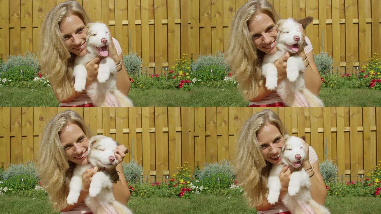 肖像: 漂亮的金发女孩和她可爱的小狗在后院玩耍。