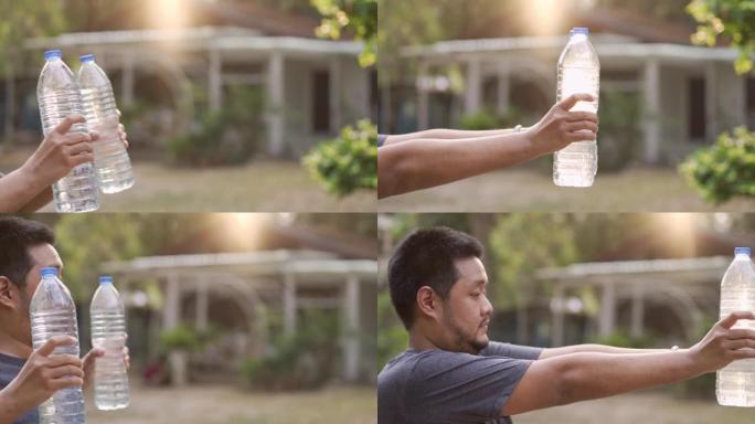 男人用水瓶代替健身房锻炼手臂和肩部肌肉