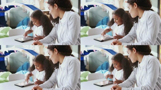 年轻的黑人女学生使用平板电脑并与女老师一对一学习，特写