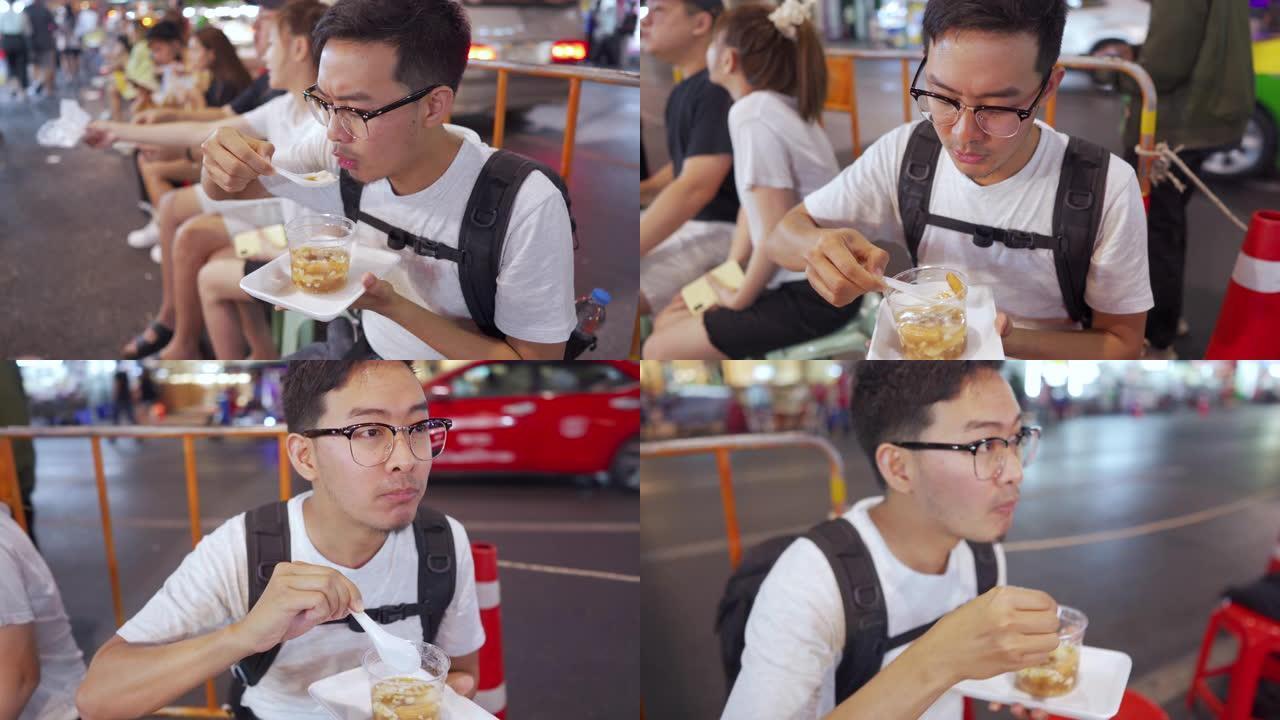 男人吃泰式甜点，在当地街头小吃中加入热姜糖浆的软豆腐