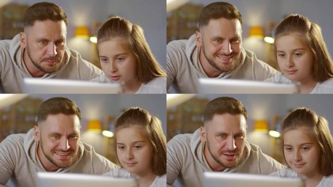 父亲和女儿一起使用数字平板电脑