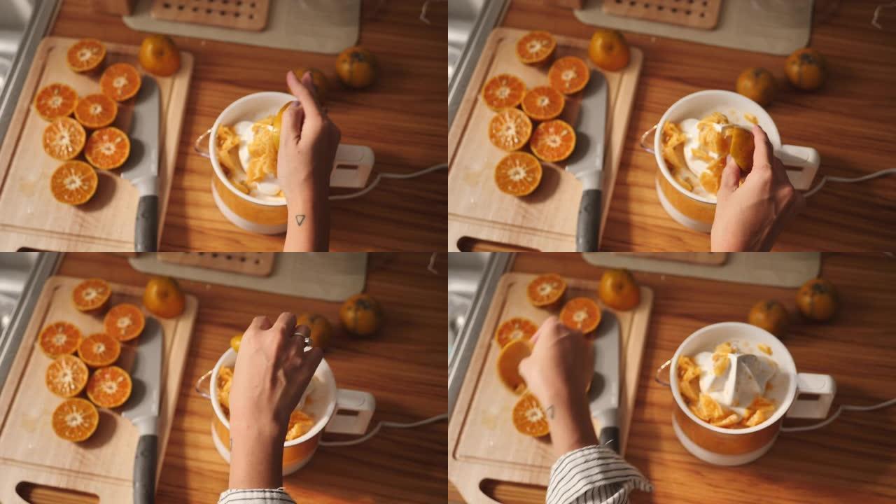 千禧一代亚洲妇女在早上做橙汁