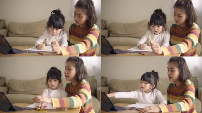 亚裔女儿在家和母亲一起参加网络课程。