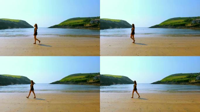 女人在微风中走在海滩上4k