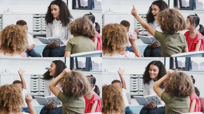 女校老师给幼儿读书，举手回答问题