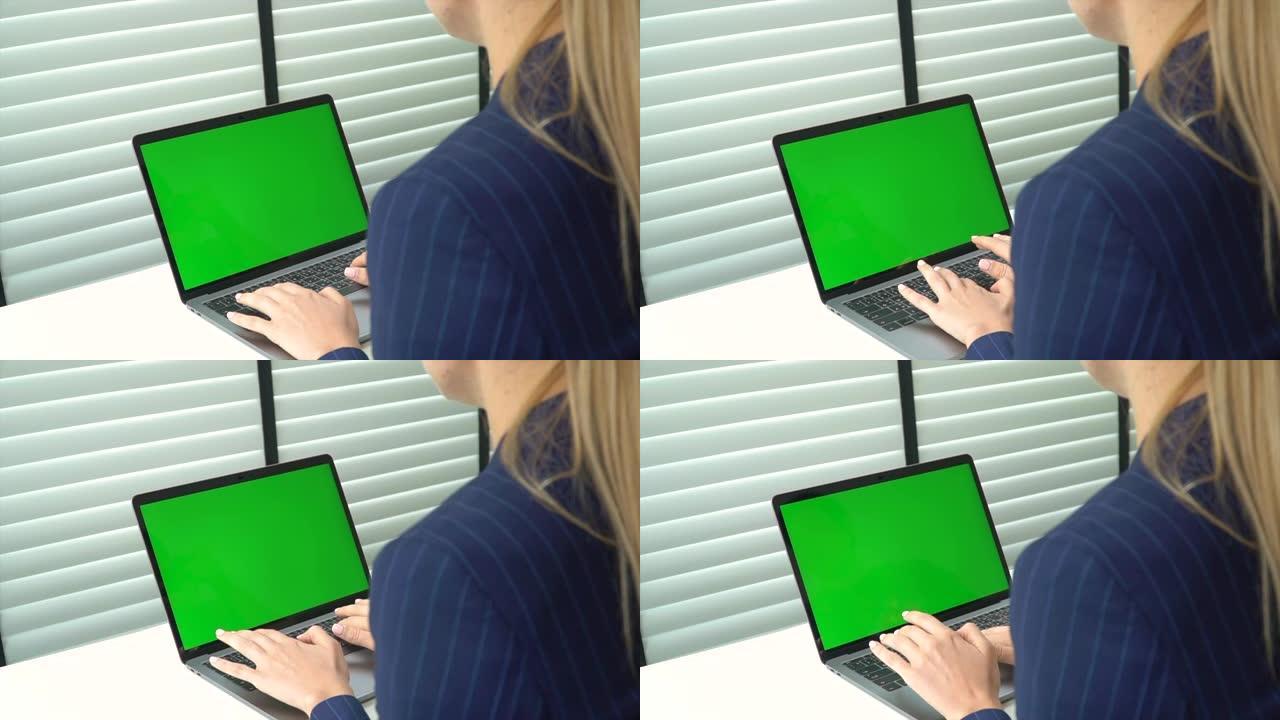 使用带有绿屏4k(UHD) 的笔记本电脑拍摄女商人的肩膀
