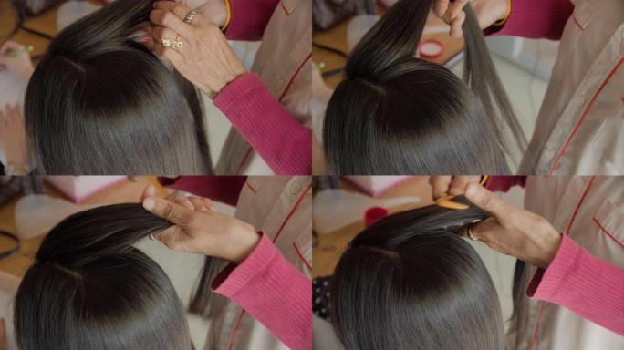 专业美发师为亚洲女性模特制作发型。