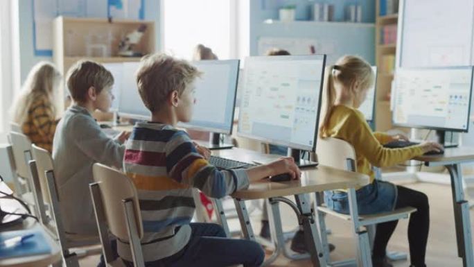 小学计算机科学教室: 聪明的小学生在个人计算机上工作，学习软件编码的编程语言。学童接受现代教育