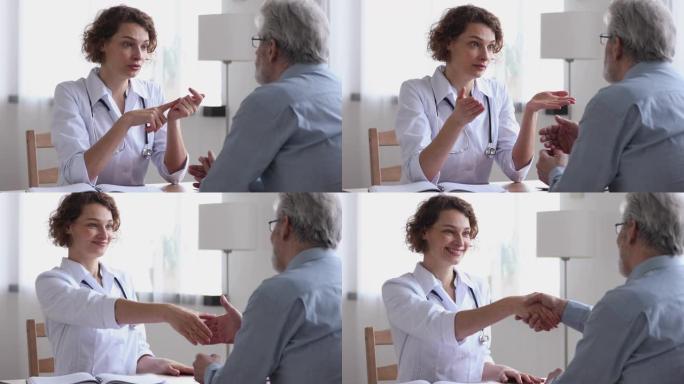 微笑的女医生提供医疗保健建议握手的高级患者