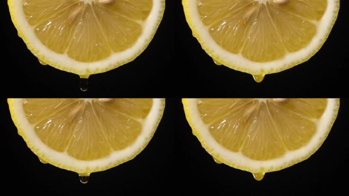 慢动作: 柠檬片上的许多液体掉落在黑色上
