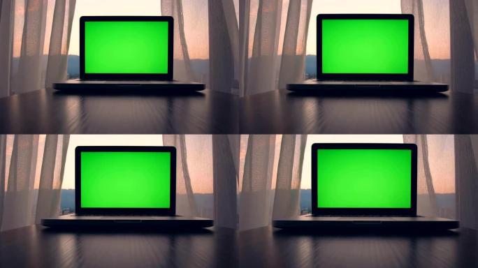 桌子上的绿色屏幕笔记本电脑屏幕