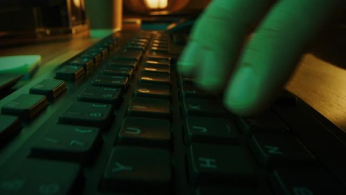 特写移动微距拍摄: 人使用鼠标，在电脑键盘上打字。工作，写电子邮件，使用互联网。晚上的绿色和黄色