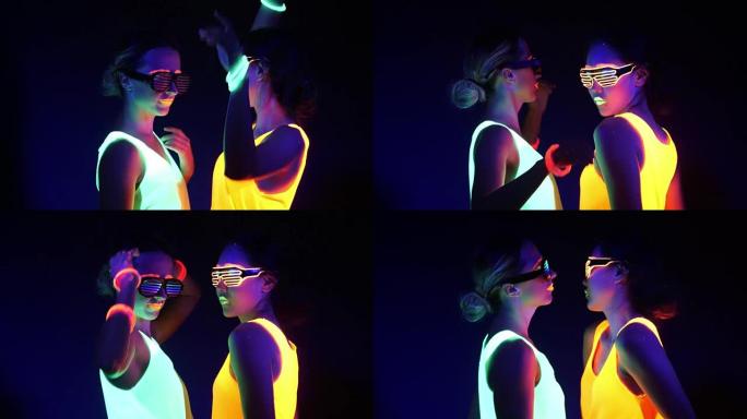 性感cyber raver女人在UV黑光下在荧光服装拍摄的梦幻视频。两个性感cyber glow r