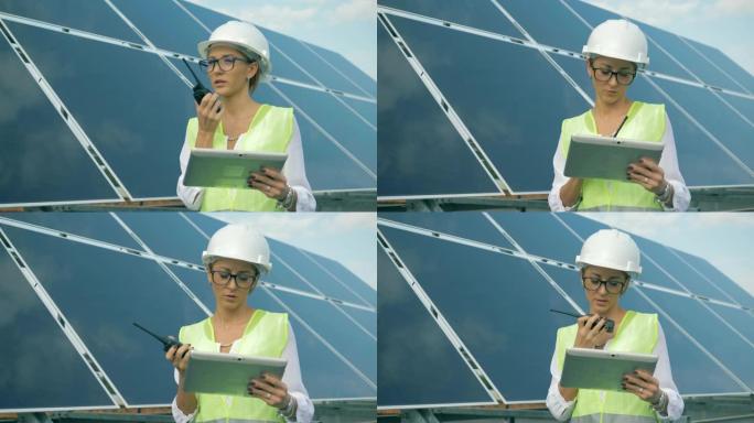 太阳能电池，一名女工程师站在旁边，在发射器上说话