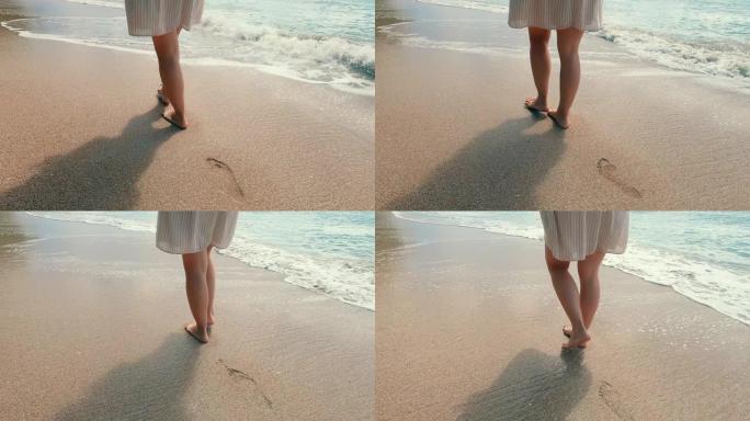 桑迪海岸和一个赤脚的女人沿着它走