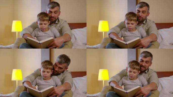 父亲读童话故事并在床上拥抱儿子