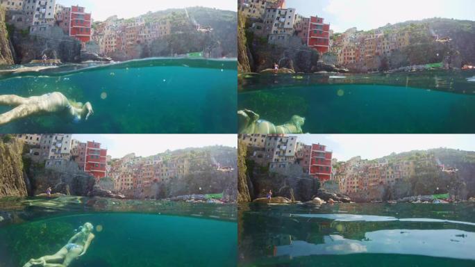 年轻女子女士在意大利五渔村的水下游泳