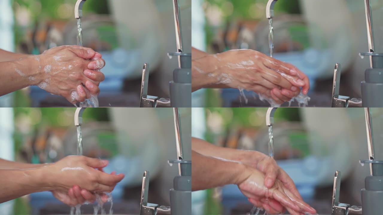 男人用肥皂和水洗手